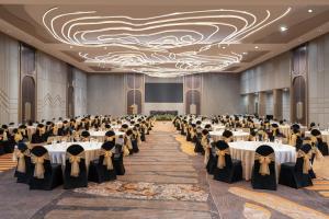 a banquet hall with tables set up for a function at Mercure Surabaya Grand Mirama in Surabaya +129 photos