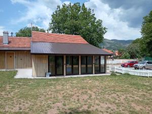 a house with a metal roof and a garage at Etno Han crvena reka in Bela Palanka