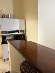 a kitchen with a wooden counter top and a microwave at Apartamento 2 quartos em Conservatória - até 9 pessoas! in Conservatória