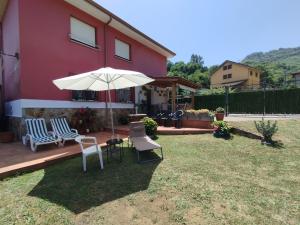 a patio with a table and an umbrella and chairs at Ca Blanca in Sorribas