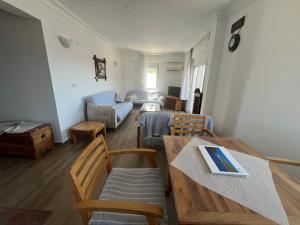 a living room with a table and chairs and a couch at Heybe Apart in Kaş
