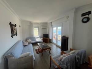 a living room with a couch and a table at Heybe Apart in Kaş