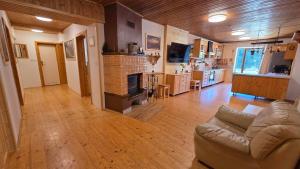 a large living room with a couch and a kitchen at Zejmarka in Mlynky