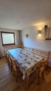 a dining room table with chairs and a table at Zejmarka in Mlynky +29 photos