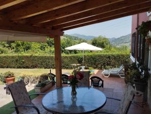 a patio with a table and chairs and an umbrella at Ca Blanca in Sorribas
