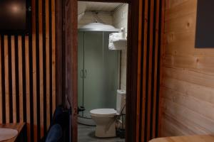 a bathroom with a toilet and a glass shower at House Riverside in Kozmacz +2 photos