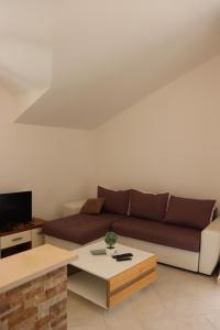 a living room with a couch and a coffee table at Aurora Residence in Nalježići