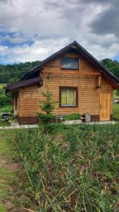 a log cabin with a window on the side of it at Chata Milka in Medzilaborce