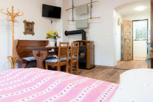 a bedroom with a bed and a table and a fireplace at Apartmán Mafin in Jáchymov