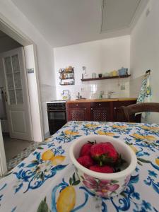 a bowl of strawberries on a table in a kitchen at Ferienappartement Tal der Liebe in Sauerthal