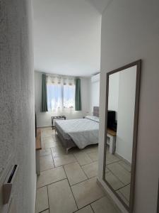 a bedroom with a bed and a mirror in it at Elyas Guest House in Villasimius