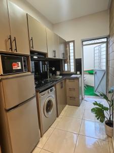 a kitchen with a refrigerator and a washer and dryer at Modern Studio in Kenitra