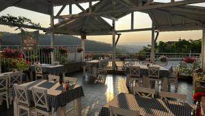 a restaurant with tables and chairs on a patio at Family Hotel Ludo in Varna City