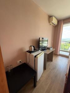 a room with a desk with a computer on it at Family Hotel Ludo in Varna City