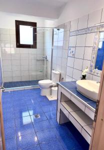 a bathroom with a toilet and a sink at Parea House in Limenaria +18 photos