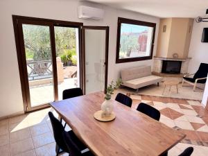 a dining room with a table and a living room at Parea House in Limenaria