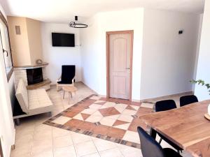 a living room with a table and a fireplace at Parea House in Limenaria