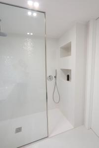 a shower with a glass door in a bathroom at Décimus Lodge - Premium Town Center Stay in Ponte de Lima