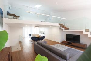a living room with a couch and a dining room at Décimus Lodge - Premium Town Center Stay in Ponte de Lima