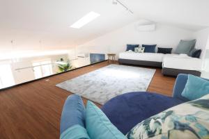 a living room with two couches and a couch at Décimus Lodge - Premium Town Center Stay in Ponte de Lima