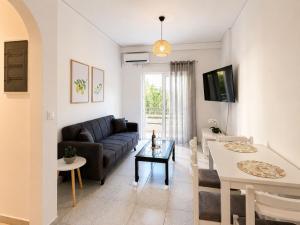 a living room with a couch and a table at Linda's Apartment in Ialysos