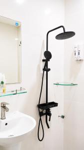 a bathroom with a white sink and a glass shelf at Beauty House in Ho Chi Minh City +43 photos