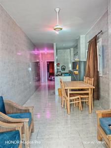 a dining room with a wooden table and chairs at See you soon blue Beach in Marsa Matruh