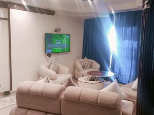a living room with a couch and a tv on the wall at City squer see view 34 in Alexandria