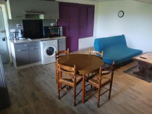 a kitchen and dining room with a table and chairs at Gite Atchoum in Hostun +1 photo