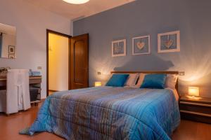a bedroom with a bed with a blue comforter at Al Casale B&B in Casalserugo