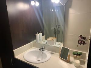 a bathroom with a sink and a shower and a mirror at Bella Javea in Jávea