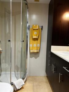 a bathroom with a shower and a yellow towel at Bella Javea in Jávea +4 photos