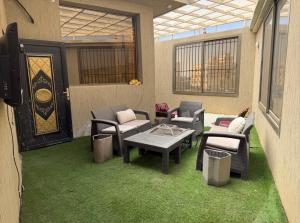 a patio with chairs and a table and chairs at راحتي in Al Baha