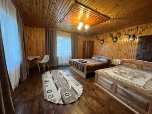 a bedroom with two beds and a couch in it at Затишний дім in Yaremche