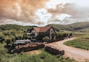 a house in a field with a dirt road at Casa Poarta Paradisului in Moldoveneşti