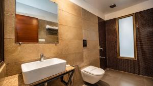 a bathroom with a sink and a toilet at Uddhav Vilas A Family Hotel in Udaipur +63 photos
