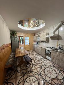 a kitchen with a table in the middle of it at Затишний дім in Yaremche