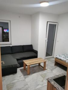 a living room with a couch and a coffee table at Villa SeFa in Struga