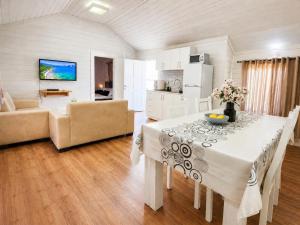 a kitchen and living room with a table and a couch at אתנחתא בירדן in Mishmār Hāyardin +12 photos