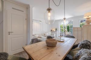 a living room with a wooden table and chairs at Strandliebe Sylt in Westerland