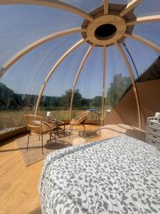 a bedroom with a bed and a table and chairs at La bulle de Clemence in Montfermy