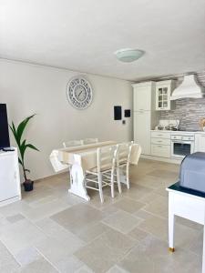 a kitchen and dining room with a table and chairs at Relax House Sardara in Sardara