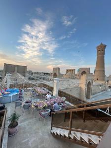 a view of a patio with tables and chairs at Golden Minaret with Terrace in Bukhara