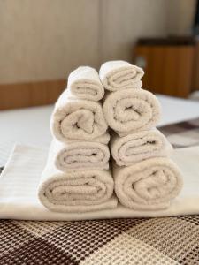 a pile of towels stacked on a white plate at Otel delfin in Karolino-Buhaz +291 photos