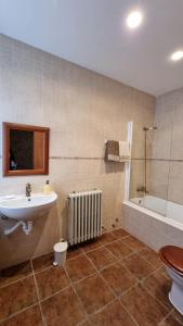 a bathroom with a sink and a bath tub at El Condado Casa Rural in Fuentes de Oñoro +34 photos