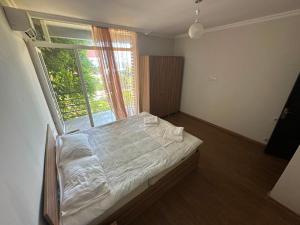 a bed in a room with a large window at Seaside cottages in Chakvi +65 photos