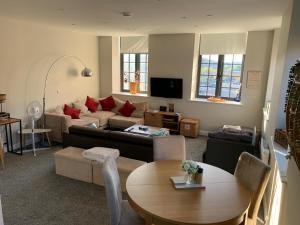 a living room with a couch and a table at Stylish apartment in Halifax in Halifax