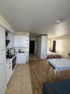 a kitchen with white cabinets and a table in a room at Smart House Home in Kyiv +121 photos