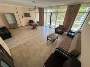 an overhead view of a living room with a couch and chairs at Seaside cottages in Chakvi