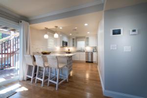 a kitchen with a island with bar stools at The Newport Lofts - 617 Thames Street in Newport